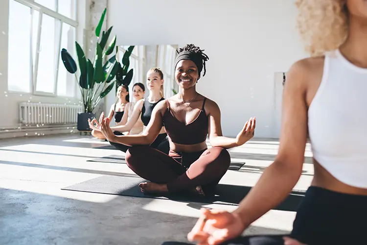 A small group practising yoga together in a bright, airy studio